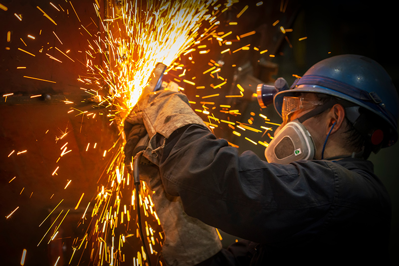 The worker polished the metal splashing sparks a person polishing metal with sparks flying